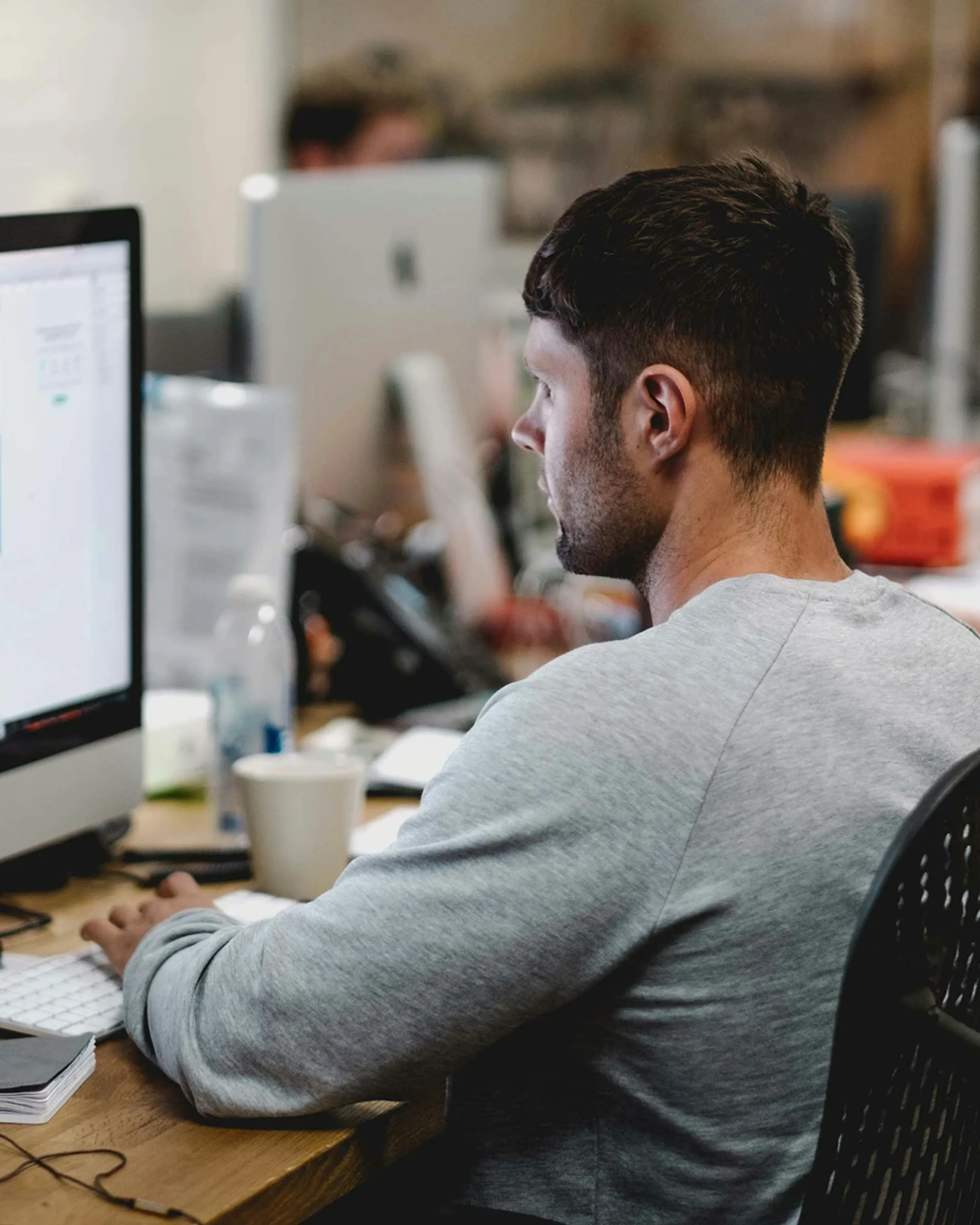 SparkVertical team working at desks in an office.