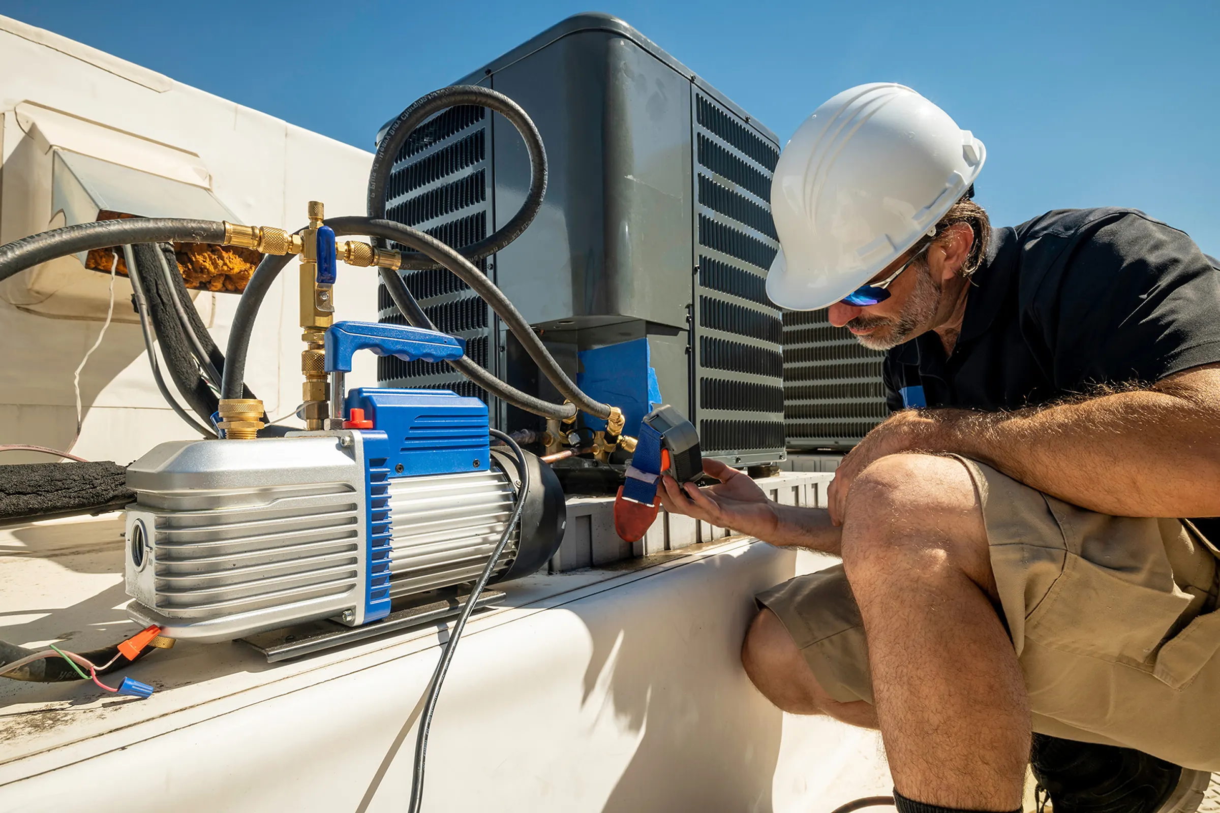 HVAC technician servicing commercial mechanical equipment.