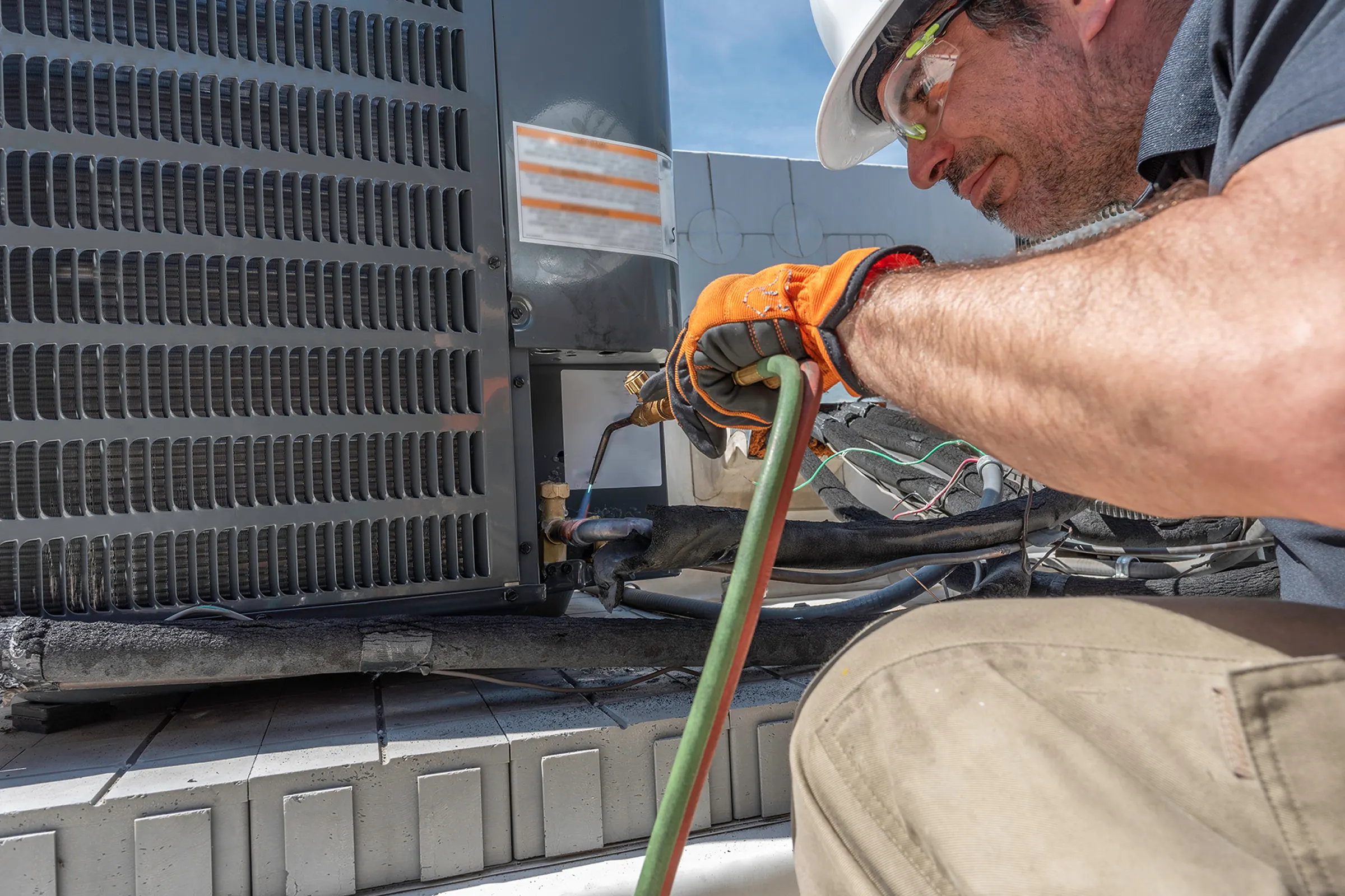 HVAC technician working near mechanical equipment.