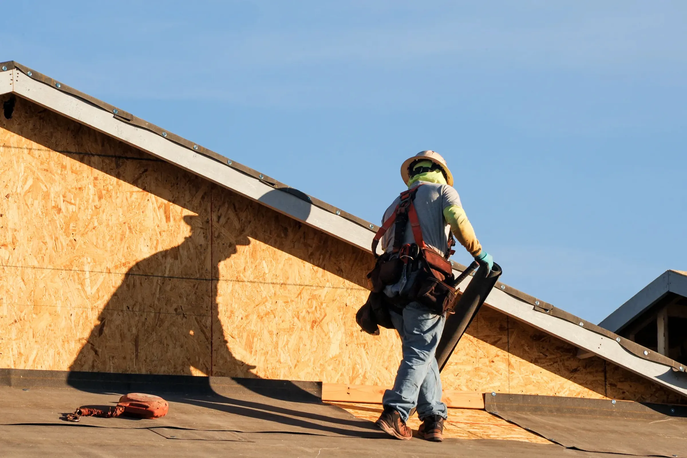 Roofing contractor working on the exterior of a home.