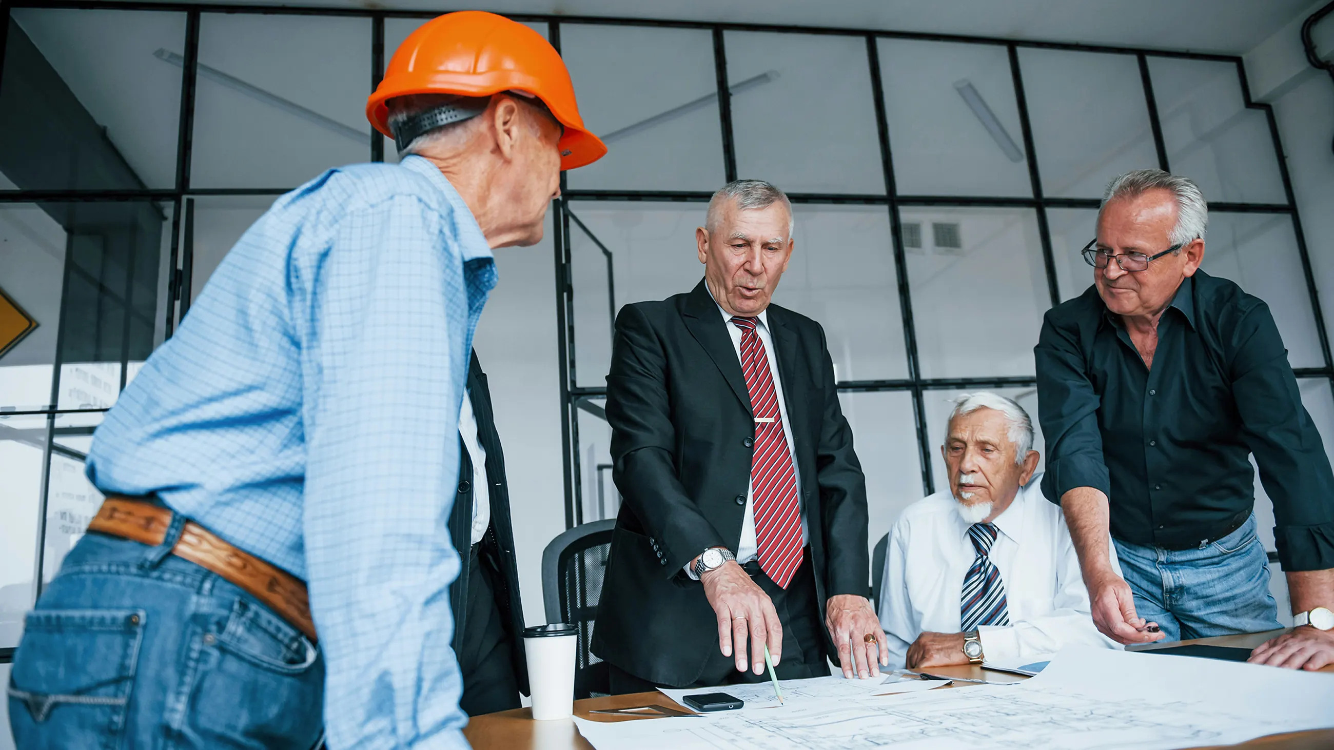 Construction company leadership team discussing a project in their office