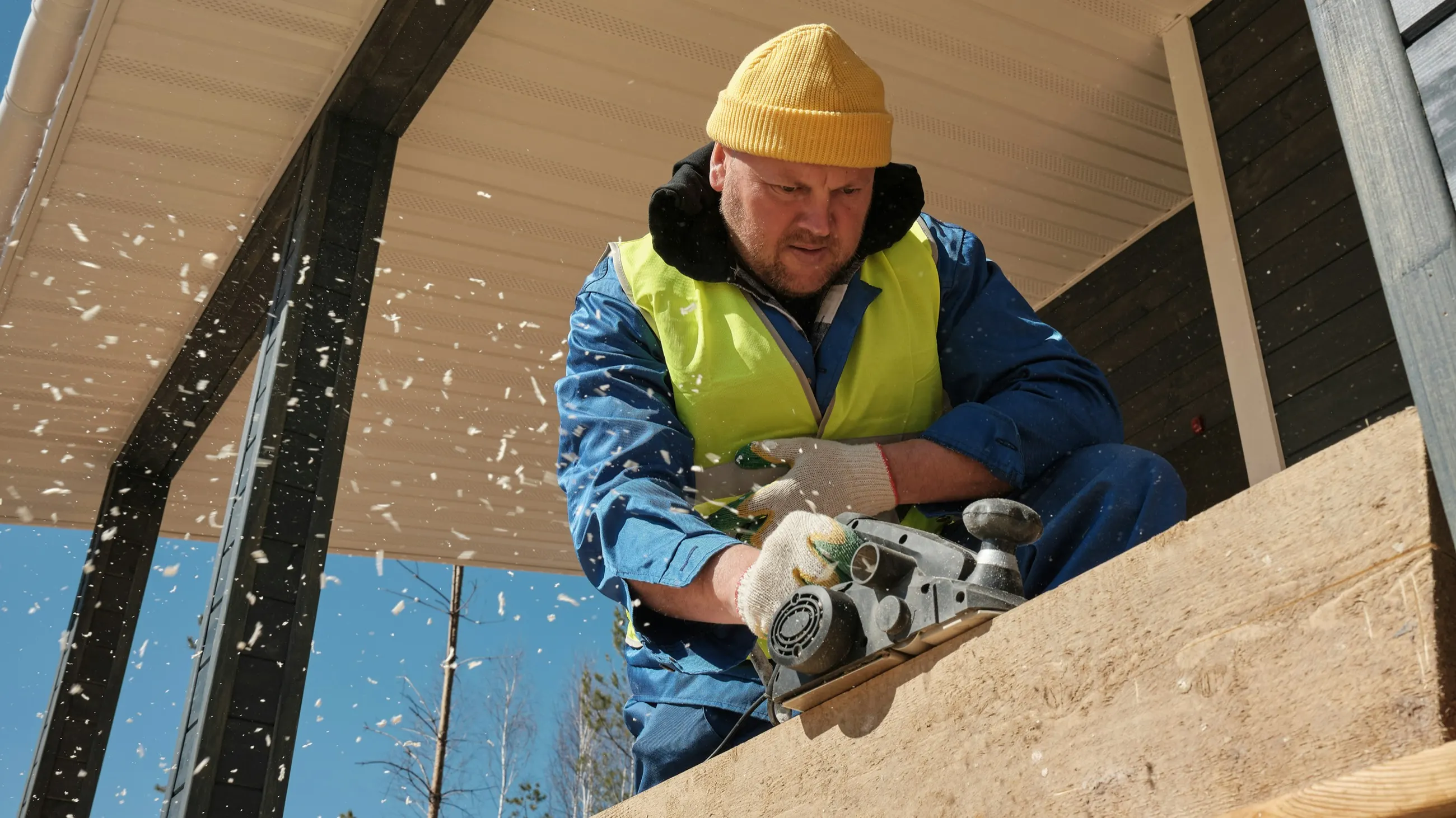 Construction worker cutting lumber on a jobsite