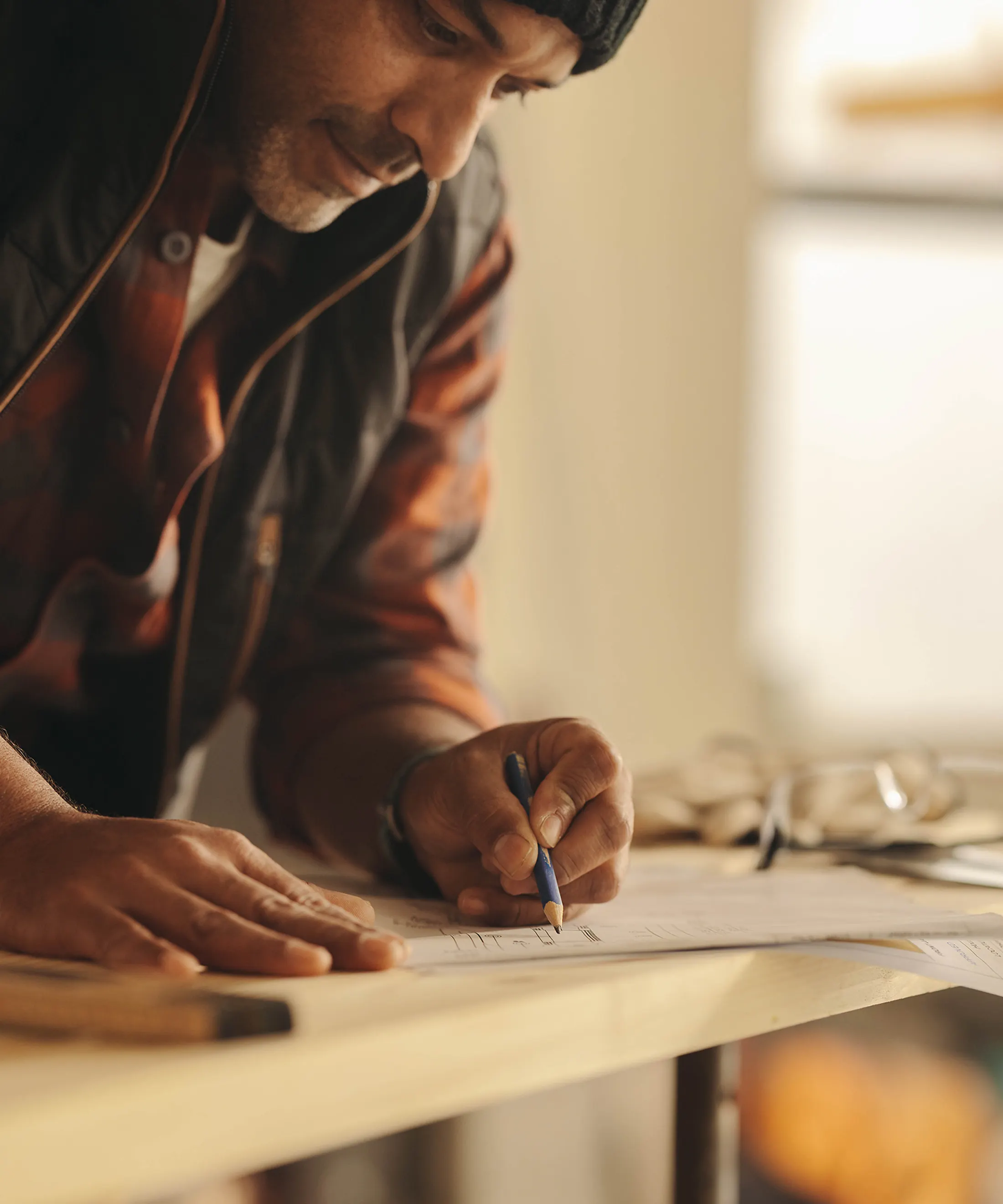 Construction and remodeling professional on-site, making notes with pencil