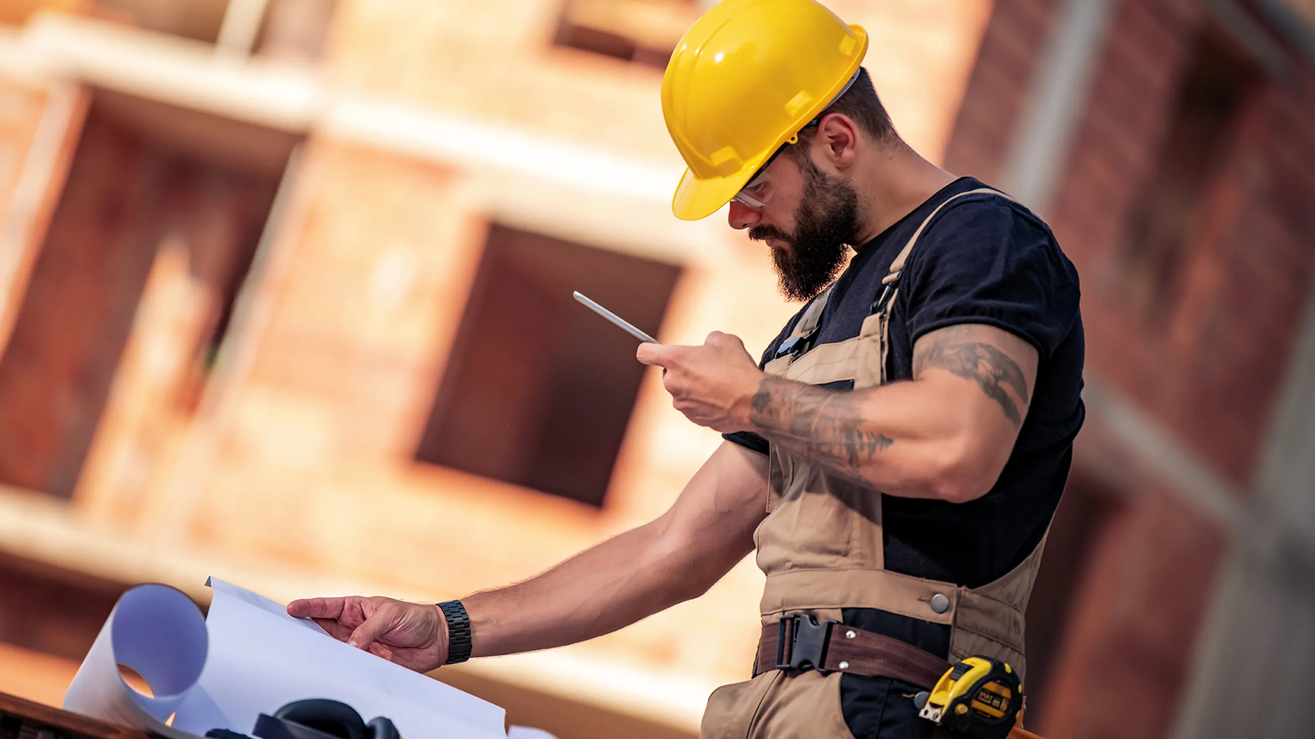 Construction company owners reviewing plans at a residential site