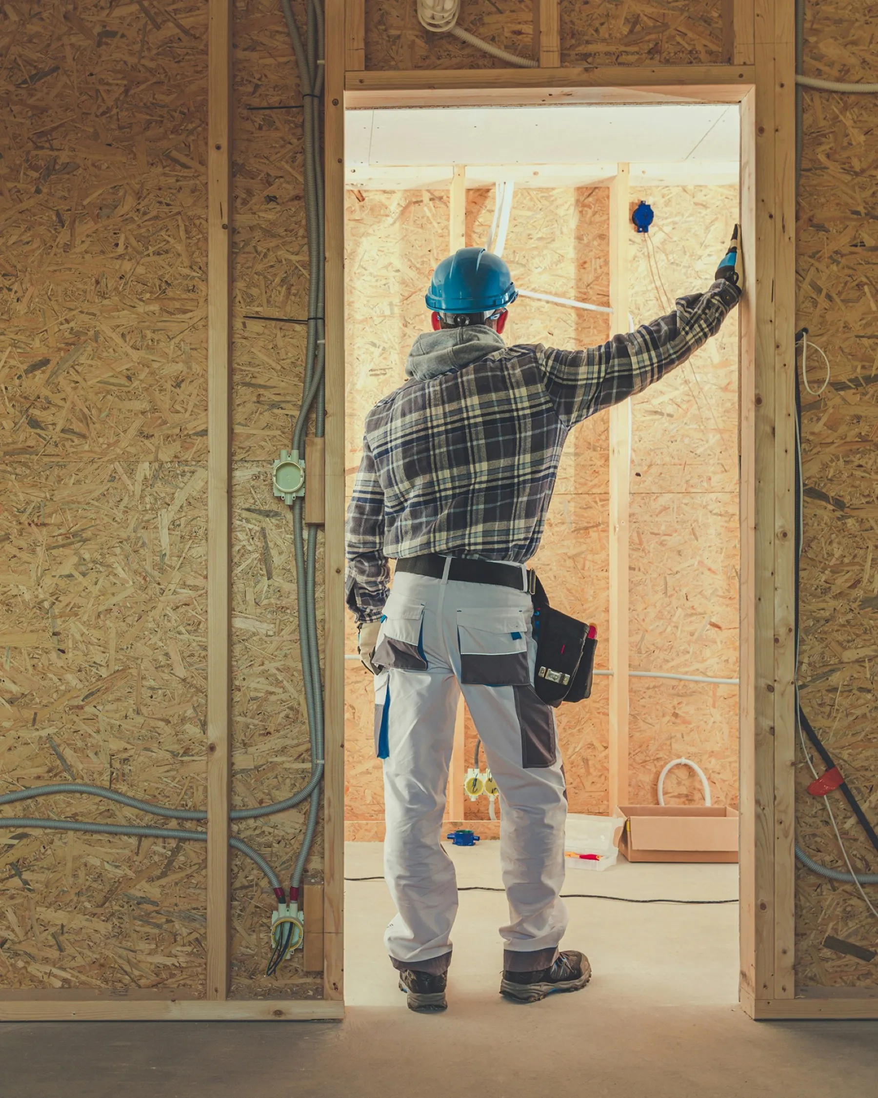 Worker framing an interior wall